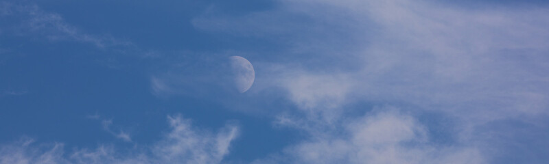 daytime sky landscape with white clouds and moon