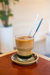 A glass of Iced coffee on the wooden table