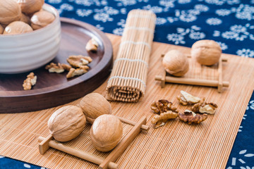 Chinese Xinjiang specialty walnuts and walnut kernels on bamboo mats