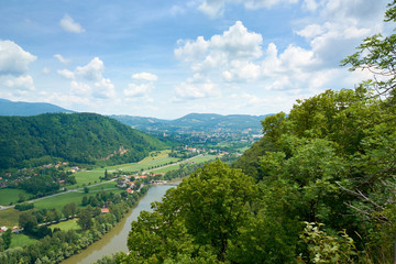 Mountains covered with forests and Mur River Valley Panorama in Graz, Austria. Summer.
