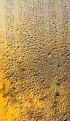 A foggy window at sunset as an abstract background