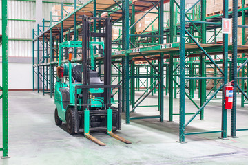 Forklifts with rack and shelf inside warehouse 