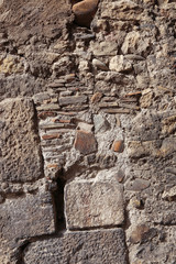 Fototapeta na wymiar Texture of an old wall of stones and bricks