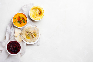 Set of vegetarian Middle Eastern Arabian eggplant,sweet potato and beet dip baba ganoush or mutabbal with seasoning on a white background top view copy space.Lebanese food snack.Horizontal orientation - Powered by Adobe