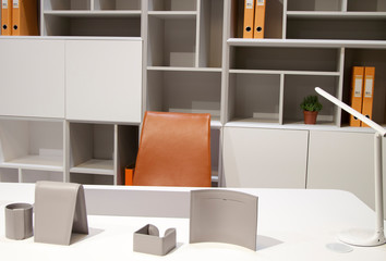 close up view of white desktop with grey accessories for successful work and white lamp
