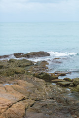 Fototapeta na wymiar Stones and rocks on the coastline of the ocean after an outflow
