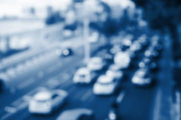 Blurred beautiful city background with road and cars toned in modern blue color 2020