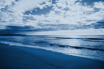 Relaxing seascape with wide horizon of the sky and the sea. Photo toned in modern blue color 2020