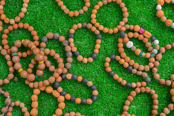 ceramic beads with leather ropes on on green grass. from chiangmai Thailand.