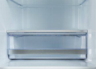 Shelves of empty modern refrigerator, closeup view