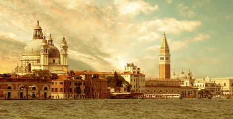 Fototapeta premium sunset on Santa Maria della Salute Basilica and St. Mark's campanile in Venice, Italy