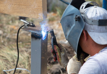 Worker welds metal at a construction site