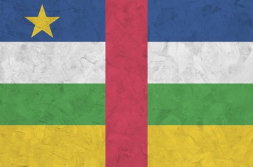 Central African Republic flag depicted in bright paint colors on old relief plastering wall....