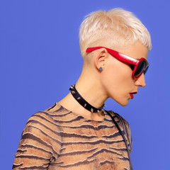 Stylish model with short haircut in fashion accessories choker and sunglasses