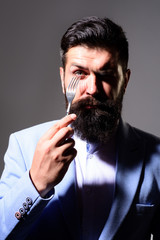 Bearded man holds silver fork. Businessman in suit holds fork in his hand. Handsome bearded man in suit with fork in his hand. Lunch or dinner. Hungry man holds fork. Diet, healthy food. Restaurant.