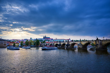 Naklejka premium A view of Prague Castle and the Charles Bridge across the Vltava River in Prague, Czech Republic.