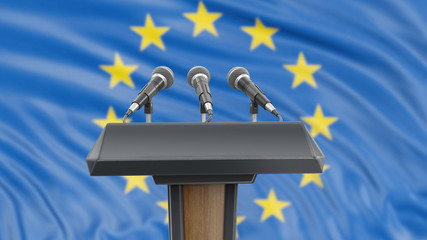 Podium lectern with microphones and European Union flag in background