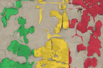 Mali flag depicted in paint colors on old obsolete messy concrete wall closeup. Textured banner on...