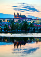Obraz premium A view of Prague Castle and the Charles Bridge across the Vltava River in Prague, Czech Republic.