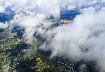 Clouds above the ground view from an airplane as a background