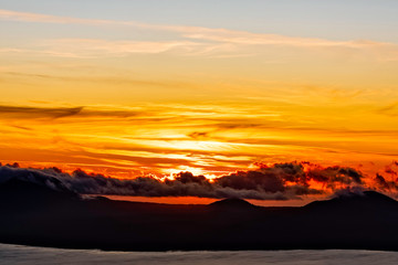 Fototapeta na wymiar Sunset over Ocean, Clouds, Mountains 