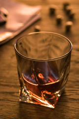 Selective focus of glass of brandy on wooden table