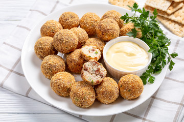 cheese balls on a white plate, close-up