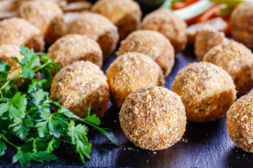 close-up of cheese balls on a black tray