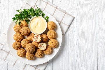 close-up of cheese balls on a white plate