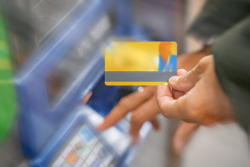 Man refills subway card at money loading machine