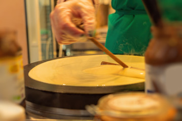 French pancake cooking process. Street food in Paris.