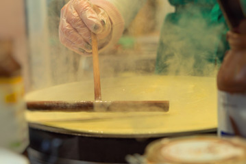 French pancake cooking process. Street food in Paris.