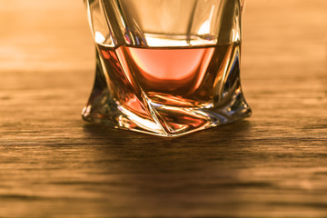 Brandy in glass on wooden table