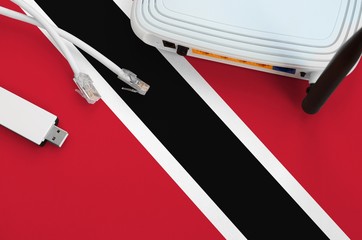 Trinidad and Tobago flag depicted on table with internet rj45 cable, wireless usb wifi adapter and...