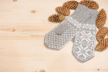 Christmas background. Woolen mittens on a wooden background.