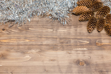 Christmas background. Colored tinsel on a wooden background.