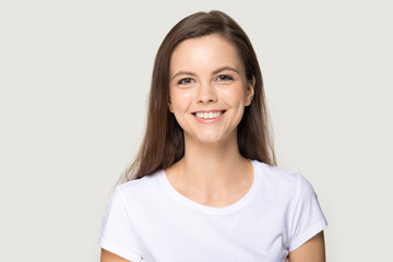 Headshot of happy millennial woman smiling looking at camera
