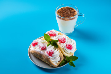 Air cake with raspberries on a saucer. Kefir with cinnamon, fermented drink.