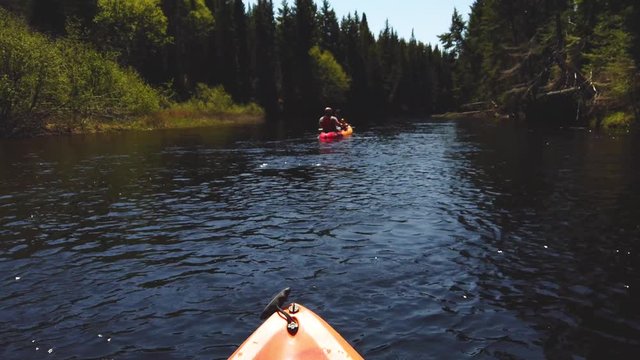 Kayak river trip through Mont Tremblant National Park forest in Quebec, Canada