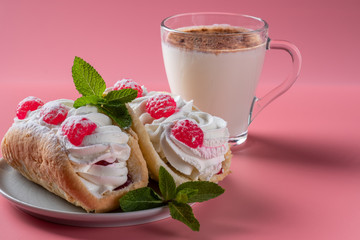 Air cake with raspberries on a saucer. Kefir with cinnamon, fermented drink. Pink background
