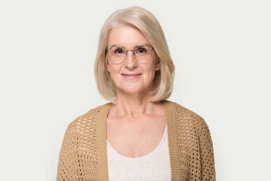 Headshot of mature woman wearing glasses looking at camera