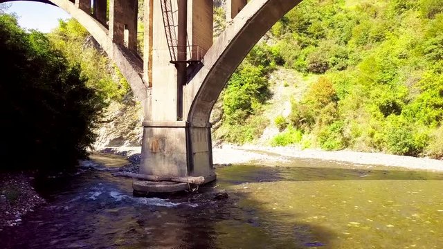 Abandoned railroad Bridge over the river in the town of Tkvarcheli. The view from the top. Eastern Abkhazia. Georgia.