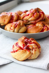Obraz na płótnie Canvas Yeast buns with raspberry jam