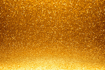 Festive golden bokeh background with sparkling glitter