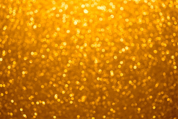 Festive golden bokeh background with sparkling glitter