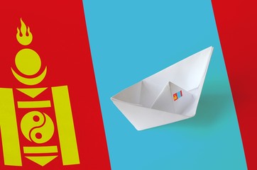 Mongolia flag depicted on paper origami ship closeup. Handmade arts concept