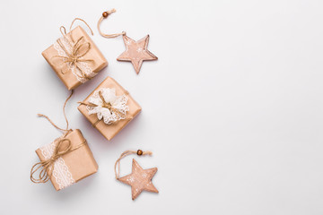 Christmas gifts decorated with natural materials and wooden star baubles. Zero Waste Christmas