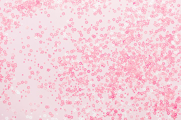 Pink pastel Stars Glitter Confetti on pink background. Festive backdrop