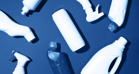 Cleaning products on classic blue background. Top view. Copy space. Chemical cleaning supplies....
