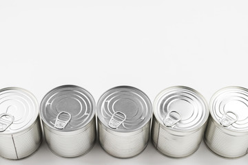 Group of silver canned food on white background.